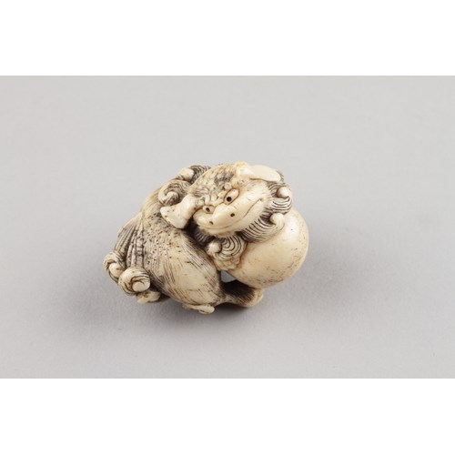 Japanese Carved Stags Horn Netsuke Depicting a Playful Shishi